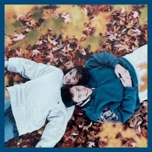 Emily and Marc in a pile of leaves