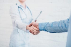 Tight shot of healthcare professionals shaking hands