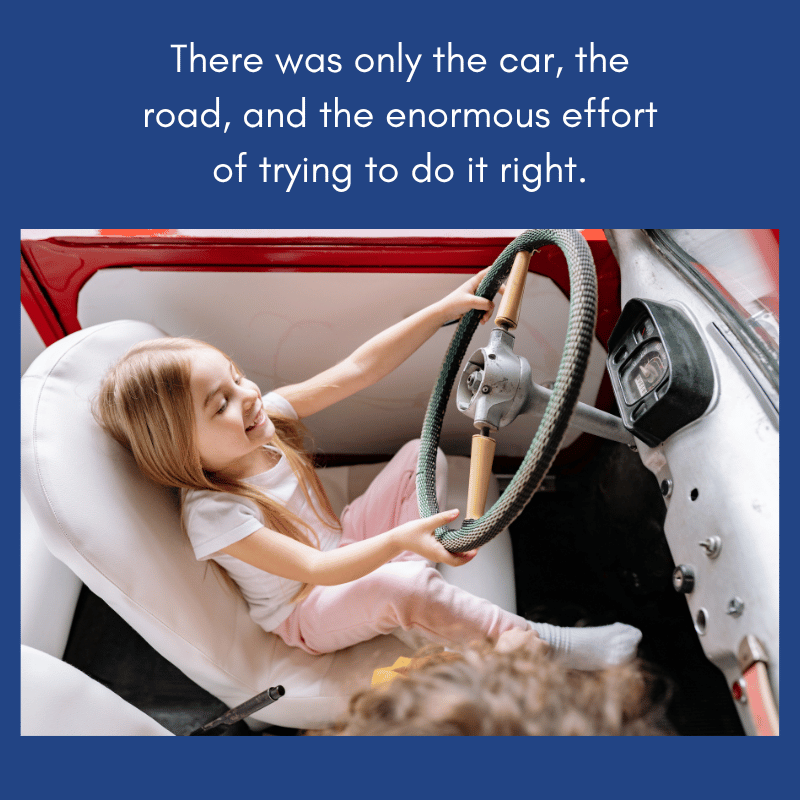 young child sitting in an old car at the steering wheel which is much taller than she is.